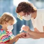 woman and child with facemasks